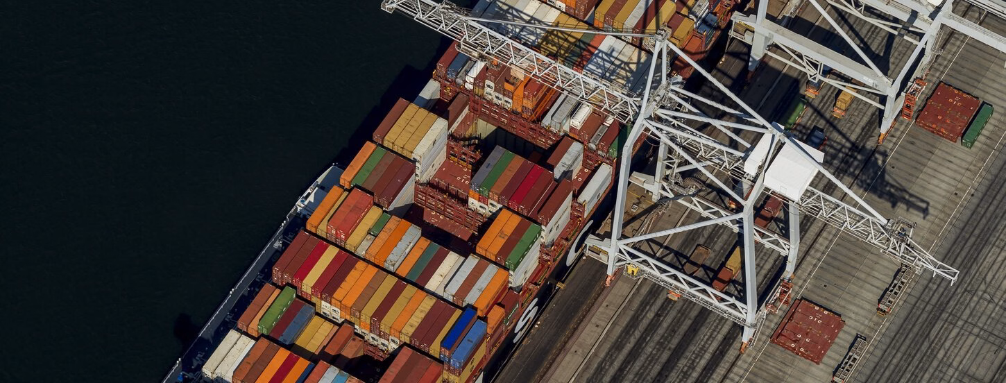 Container ship in terminal under cranes