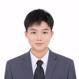 Headshot of a young Asian man in a charcoal suit and black tie, neutral expression, white background
